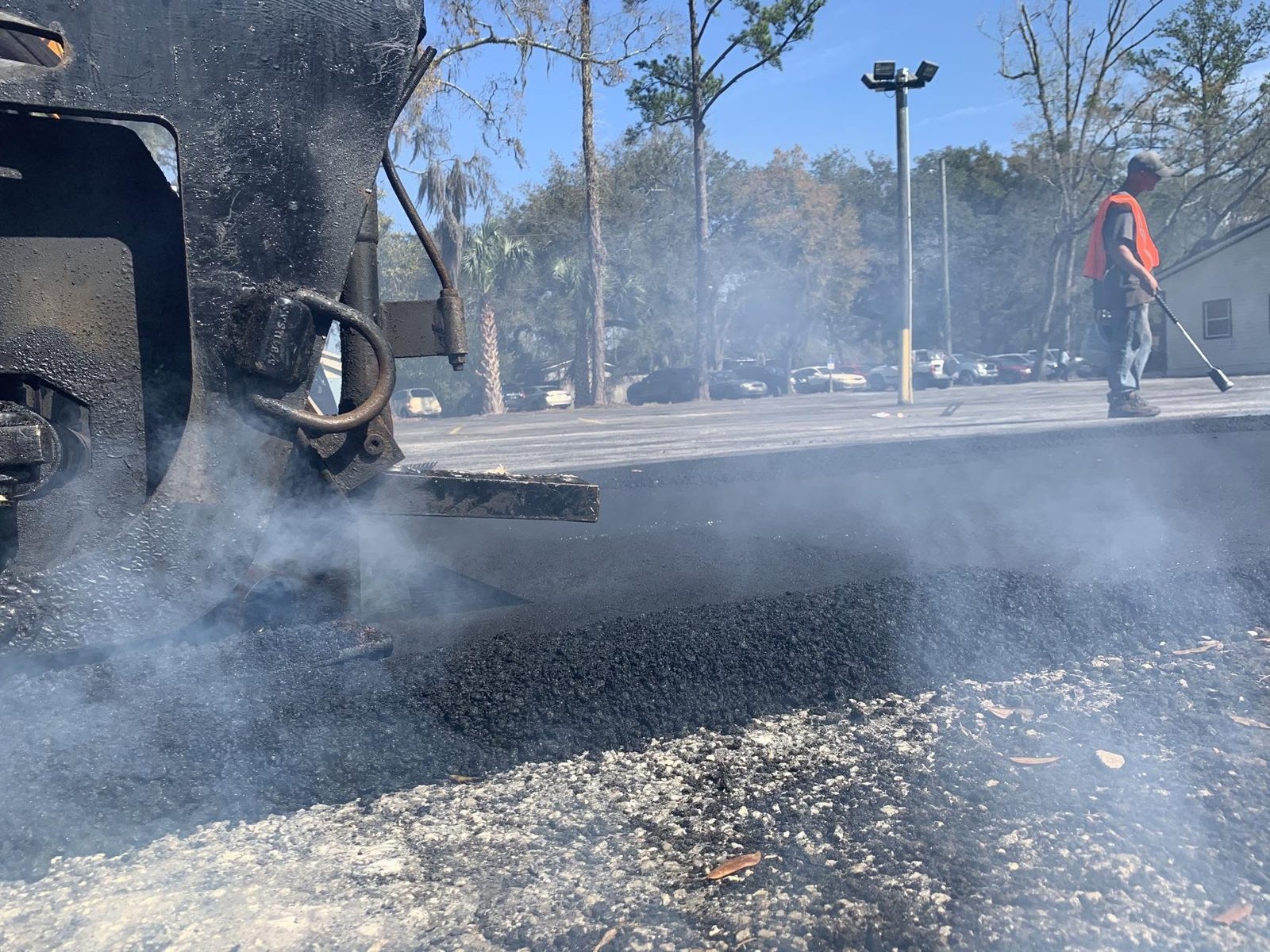 Armour Asphalt paver laying hot mix asphalt on a Gainesville parking lot