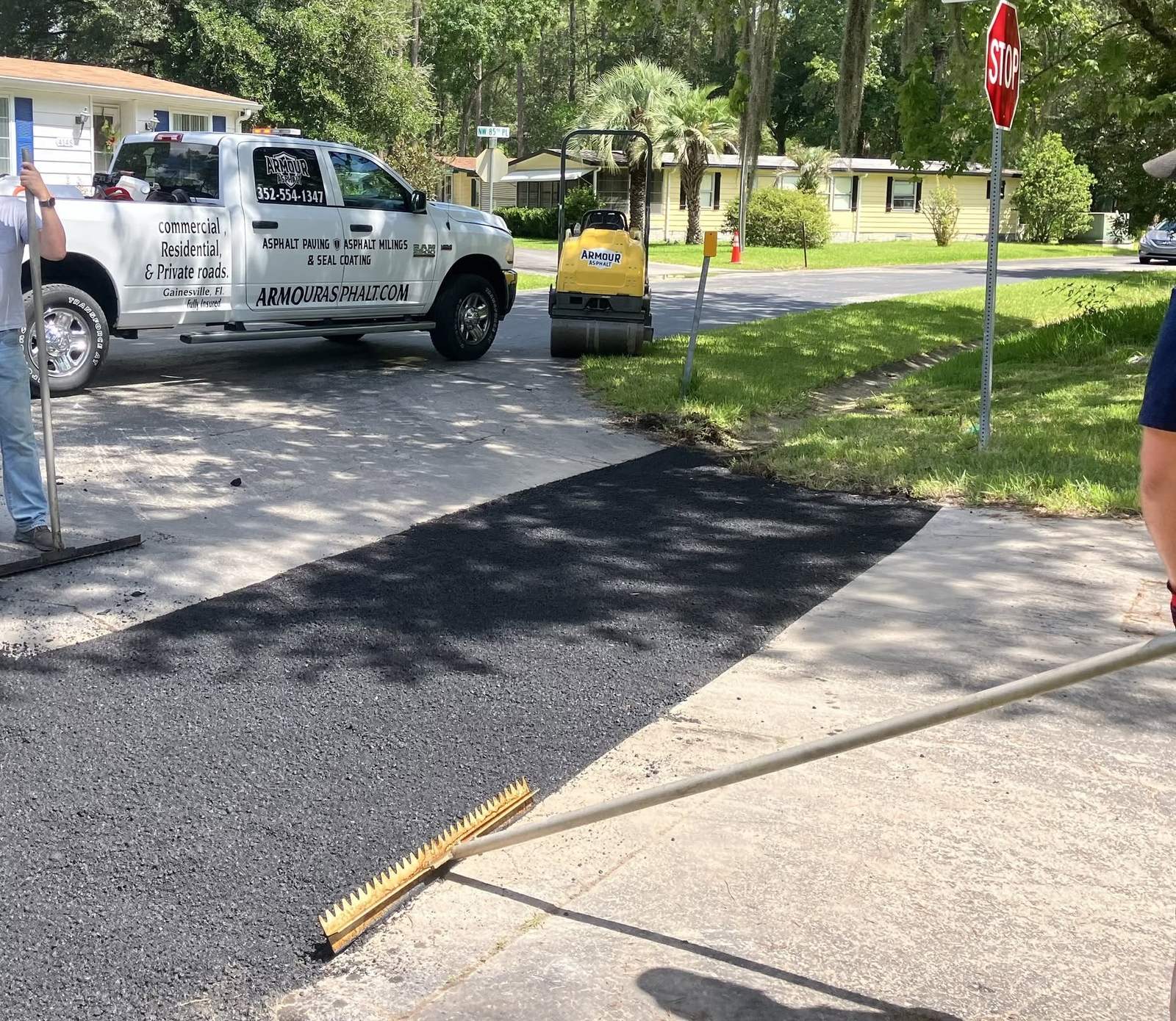 Armour crew patching a cracked street apron with fresh hot mix asphalt