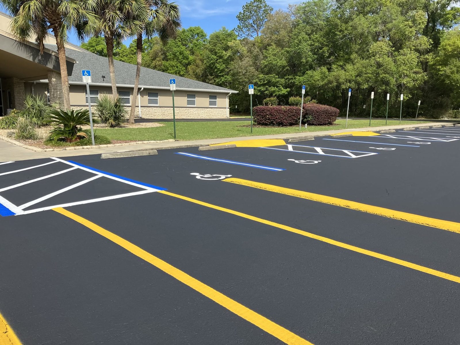 Sealcoated parking lot with crisp new yellow, white and blue striping