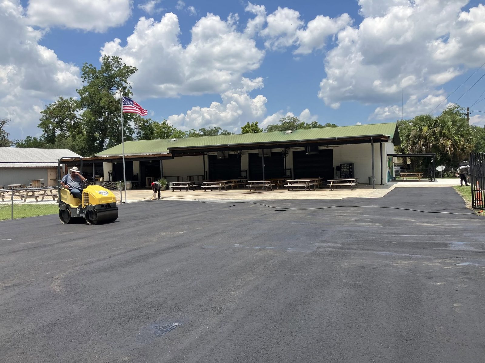 Roller compacting fresh asphalt on a commercial parking lot