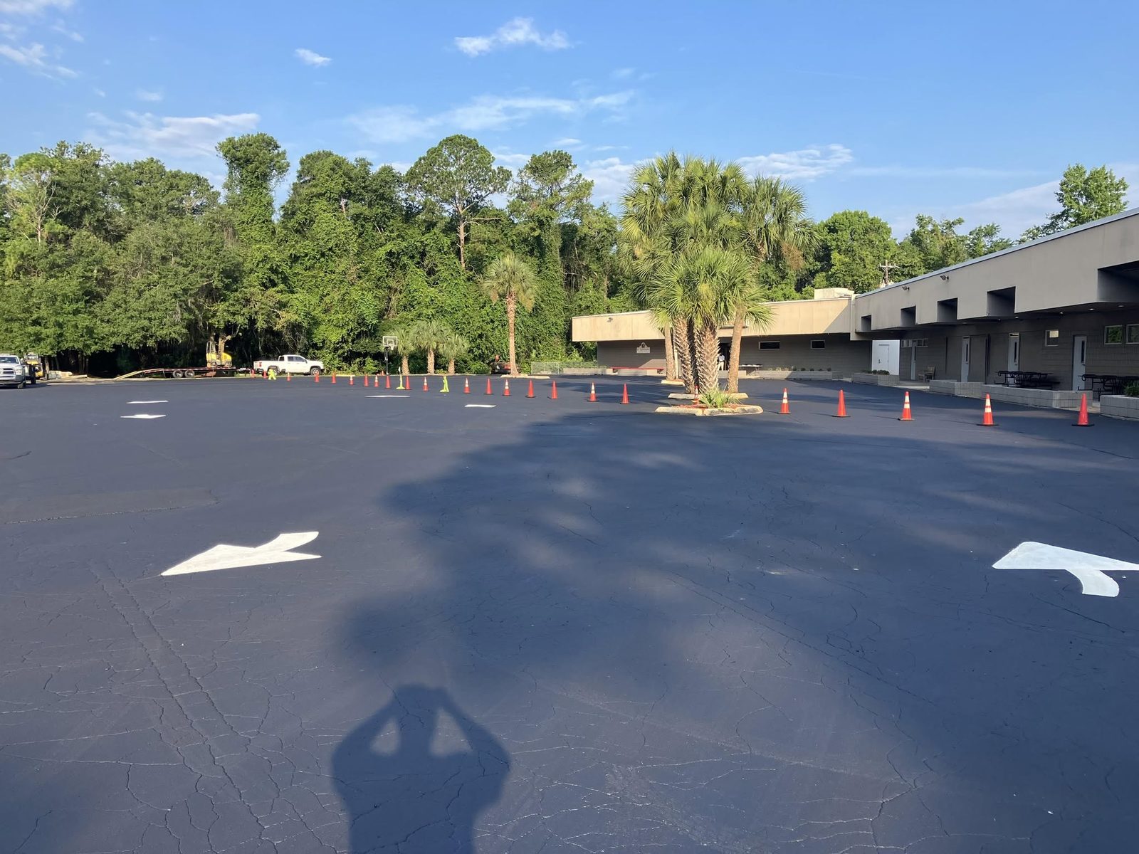 Freshly sealcoated commercial parking lot with new arrows